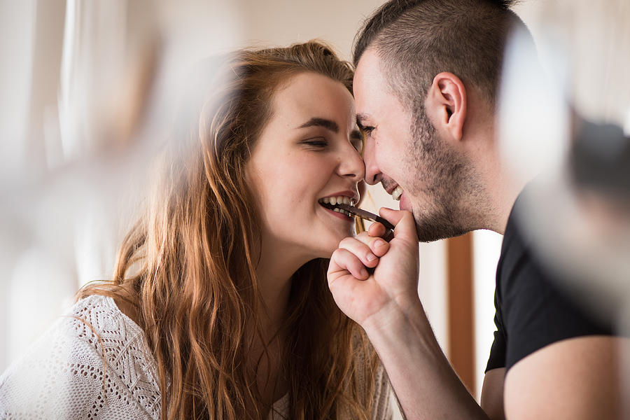 Closeness of a couple while sharing chocolate Photograph by Martin Novak