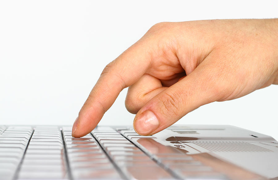 Closeup of a hand about to press on a keyboard Photograph by Oonal
