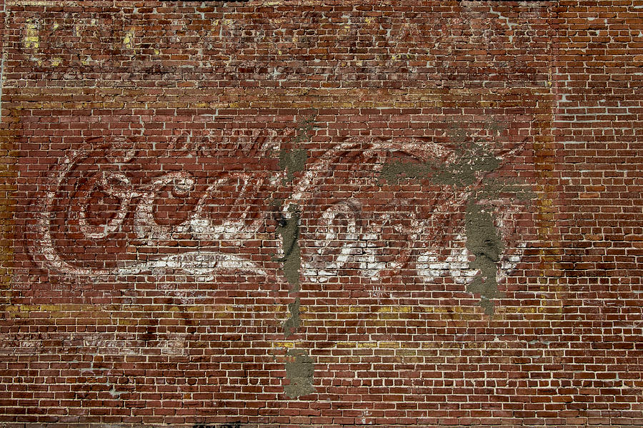 Coca Cola on Brick Wall Photograph by Bert Peake