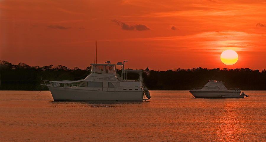 Cabin Cruiser and Red Sunset Over Harbour Photograph by Ginger Wakem