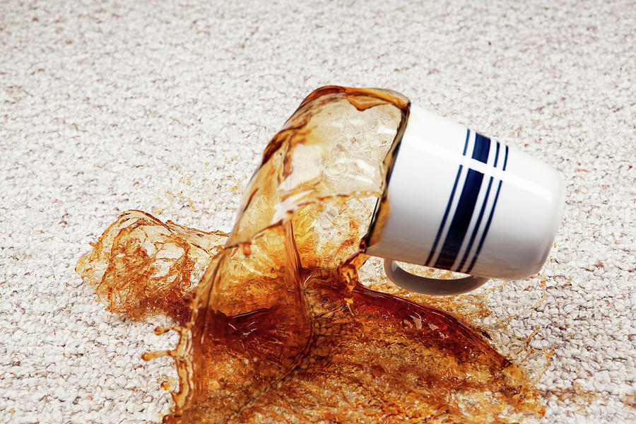 Coffee Spilling From Cup Onto Carpet Photograph by Banksphotos