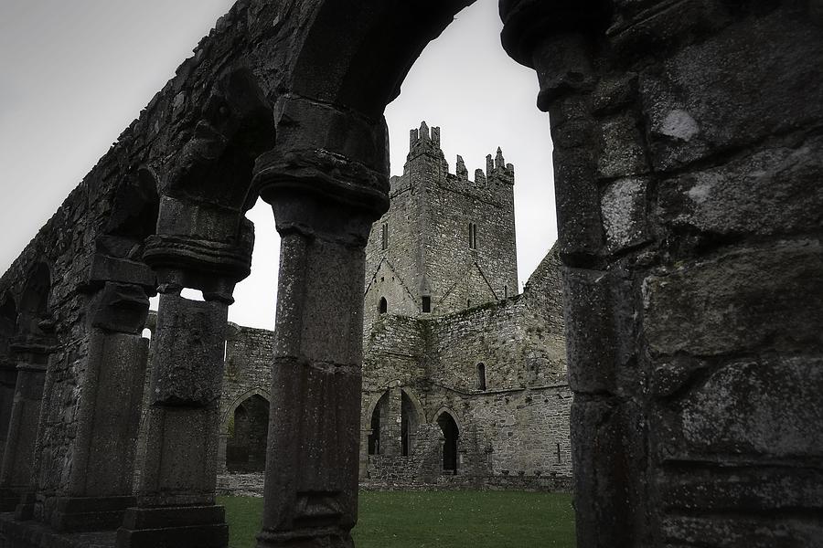 Colonnade and Tower of Jerpoint Abbey Photograph by Nadalyn Larsen