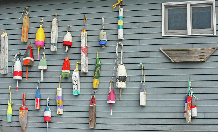 Colorful Buoys Hanging On Side Of House Photograph by Heather Paul