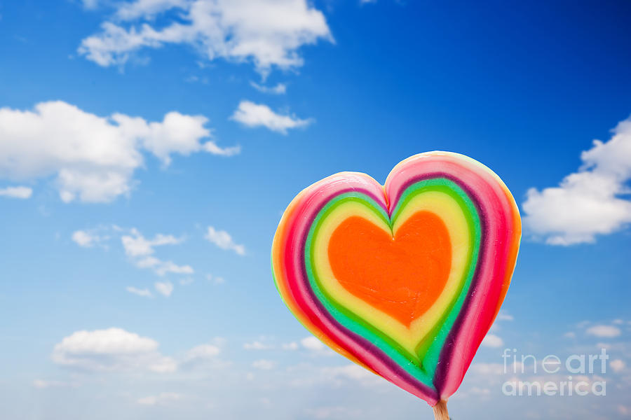 Candy Photograph - Colorful heart shaped lollipop on sky background by Michal Bednarek