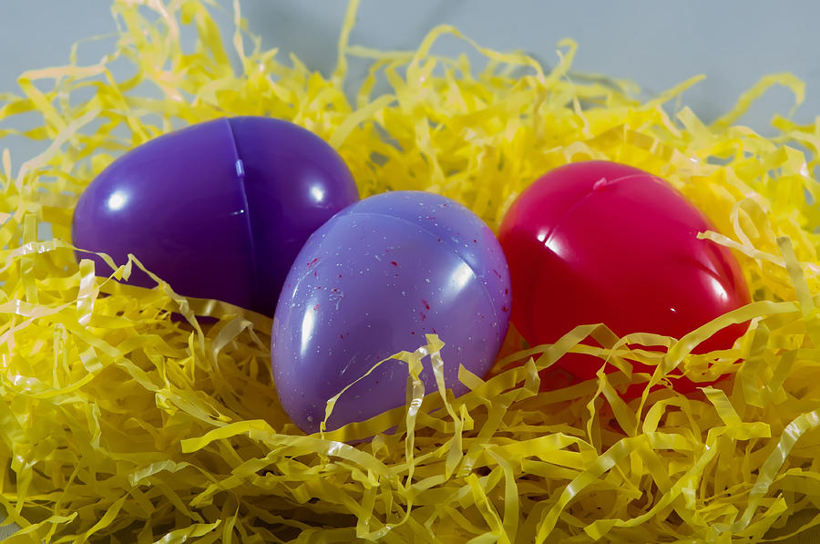 Colorful Plastic Easter Eggs In Fake Hay Photograph by Alex Grichenko