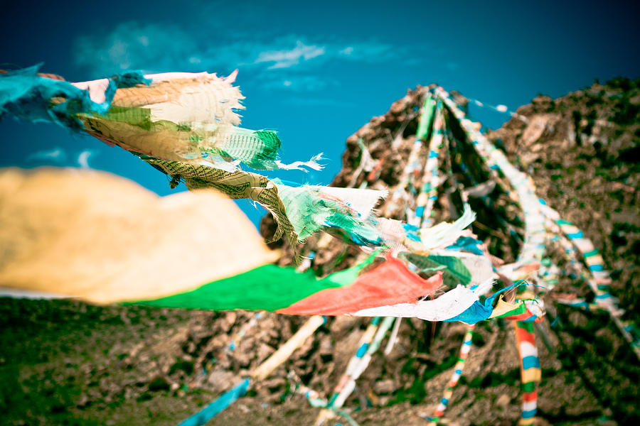 Colourfull praying buddhist flags lungta and mountain at background Photograph by Raimond Klavins