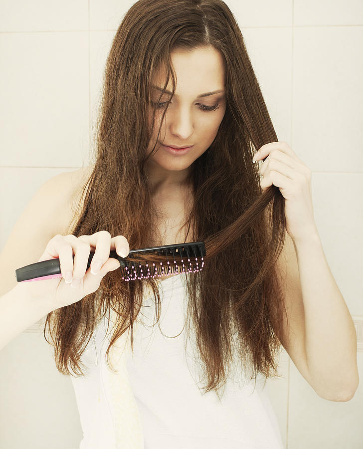 Combing hair Photograph by DKart