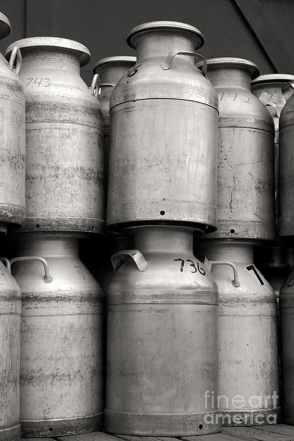 Black And White Photograph - Commercial Milk Cans Black and White by Iris Richardson