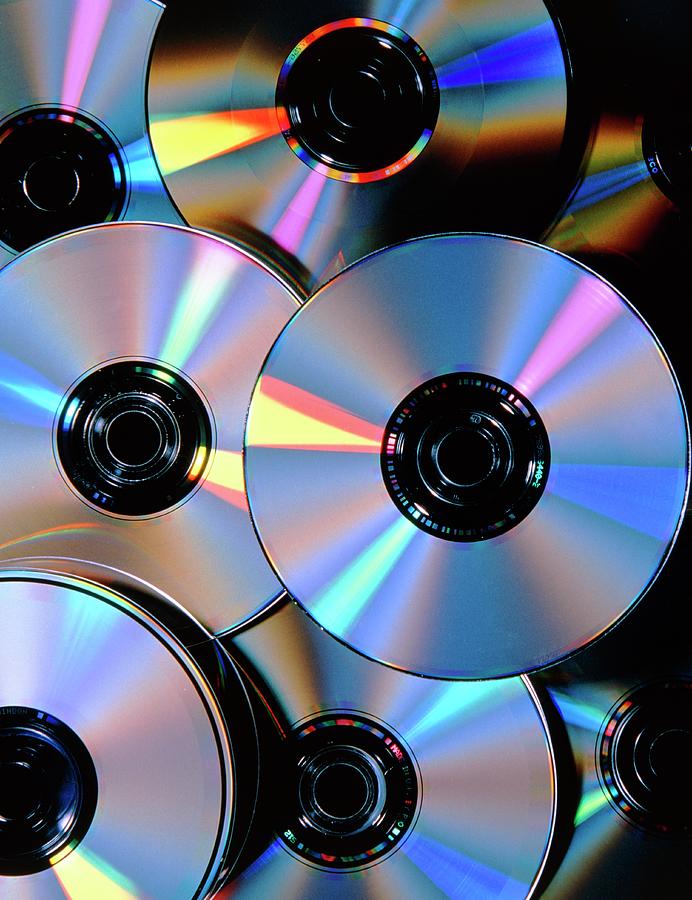 Compact Discs With Light Interference Patterns Photograph by Damien Lovegrove/science Photo Library