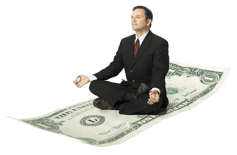 Conceptual Shot Of An Adult Business Man In A Suit As He Mediates Atop A Dollar Bill Photograph by Photodisc
