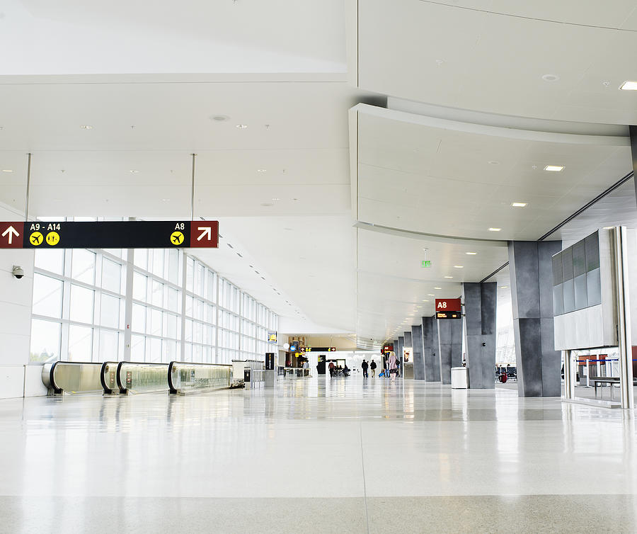 Concourse at airport terminal Photograph by Thomas Barwick
