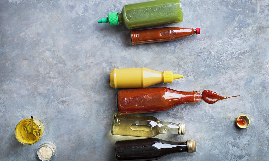 Condiments in bottles Photograph by Johner Images