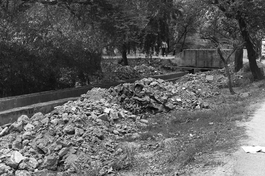 Construction debris on both sides of a drain in the Delhi Zoo Photograph by Ashish Agarwal