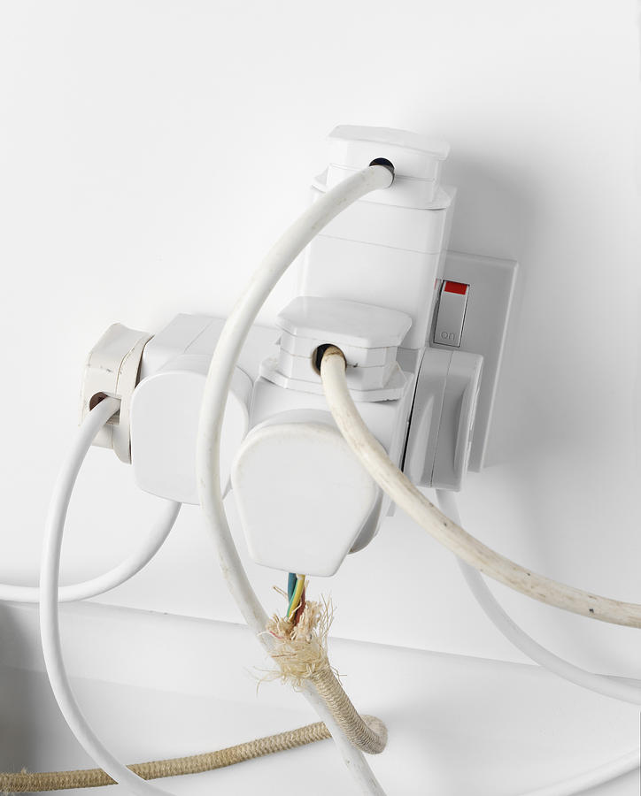 Cords in overused outlet Photograph by Mark Wragg