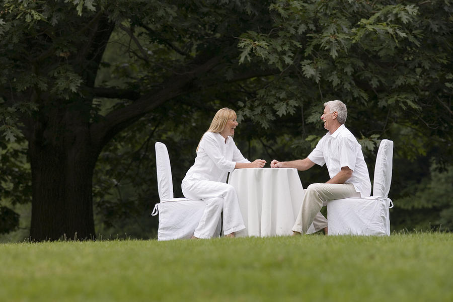 Couple dining outdoors Photograph by Comstock Images