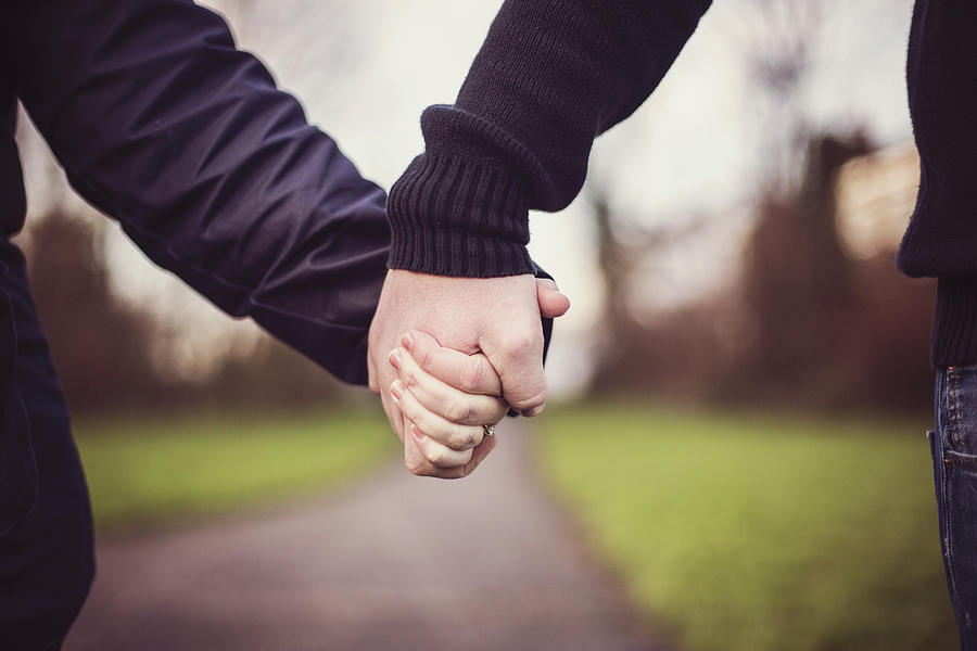 Couple holding hands Photograph by Sally Anscombe