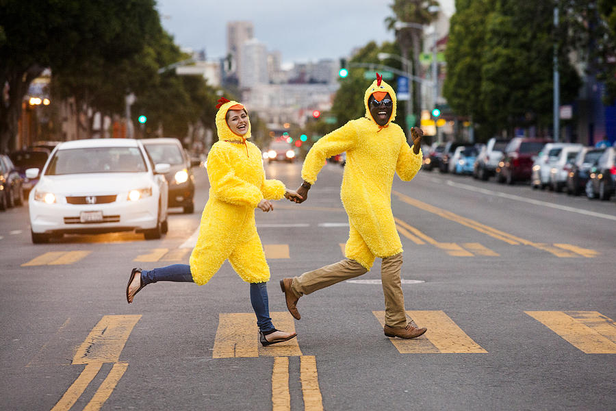 Couple in chicken costumes crossing city street Photograph by Adam Hester