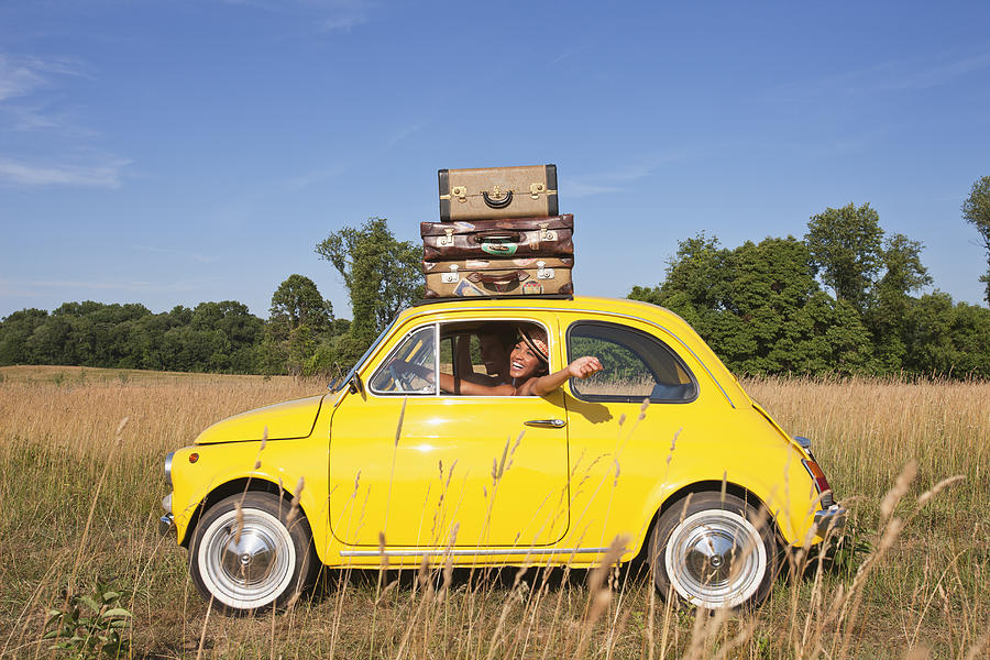 Couple in old-fashioned car on road trip Photograph by Jon Feingersh Photography Inc