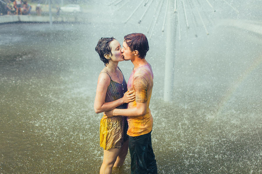 Couple kissing in fountain Photograph by Oleh_Slobodeniuk