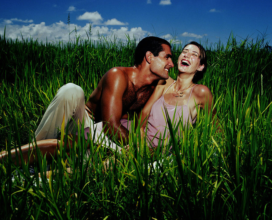 Couple laughing in rice field Photograph by Emmanuel Faure