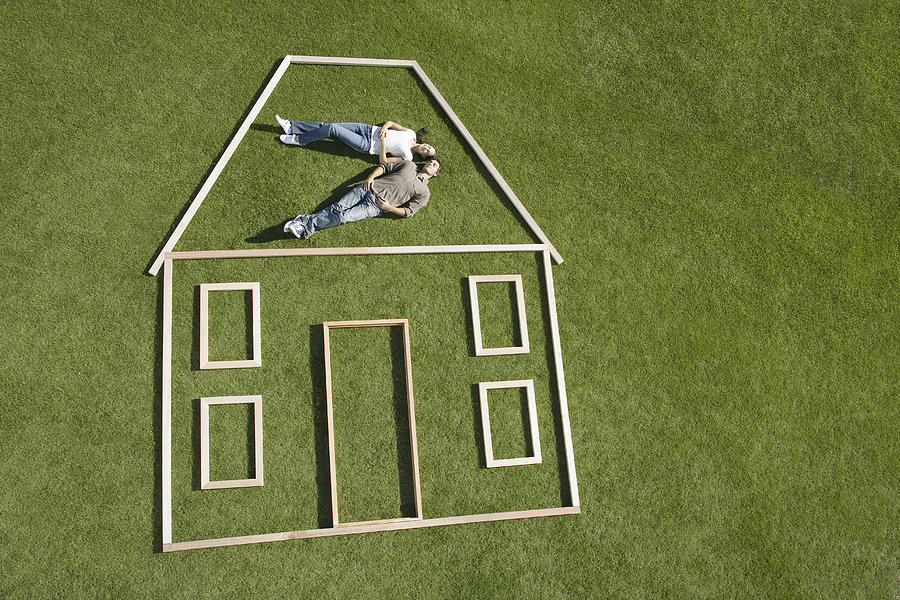 Couple laying inside house outline Photograph by Martin Barraud