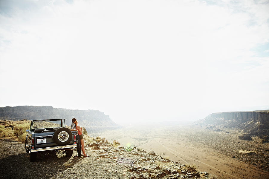 Couple Leaning Against Convertible On Photograph by Thomas Barwick Couple Leaning Against Convertible On Photograph by Thomas Barwick