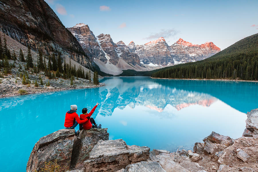 Couple looking at Moraine lake, Banff, Canada Photograph by Matteo Colombo