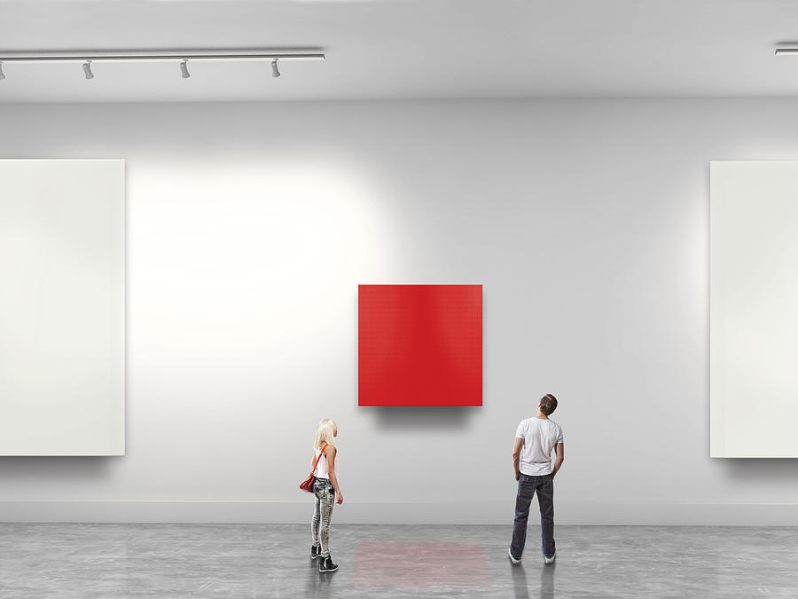 Couple looking at red blank art in gallery Photograph by Paper Boat Creative