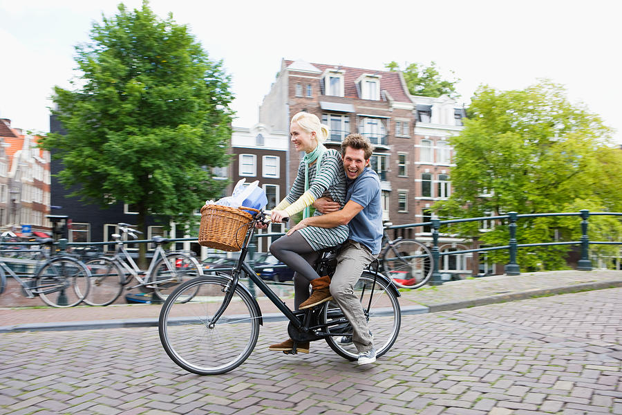 Couple on bicycle Photograph by Image Source