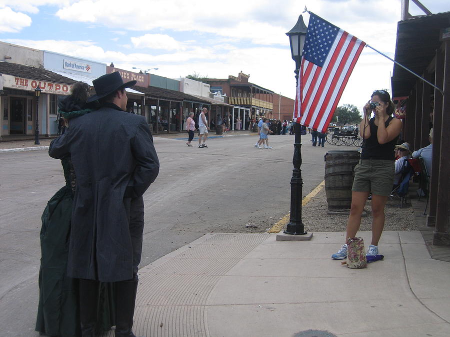 Couple photographed by shooter under American flag  Allen Street Tombstone Arizona 2004 Photograph by David Lee Guss