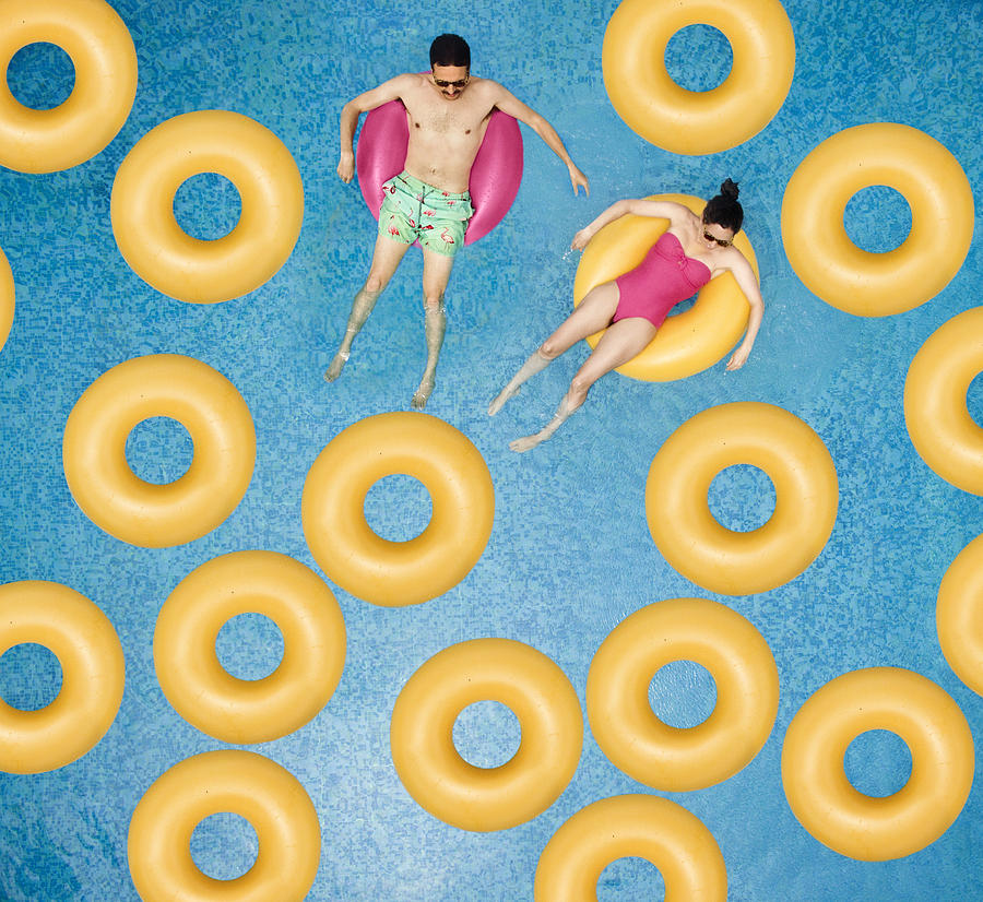 Couple relaxing at swimming pool Photograph by Orbon Alija