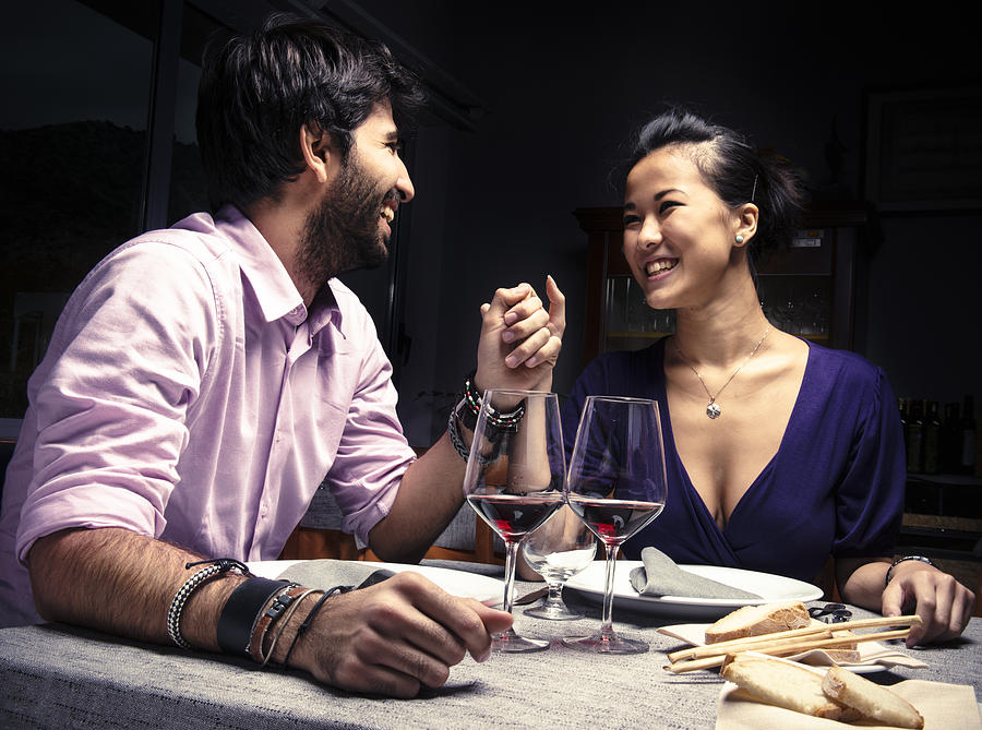 Couple smiling with red wine for St. Valentine Photograph by Franckreporter