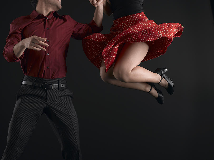 Couple swing dancing, low section Photograph by Ryan McVay