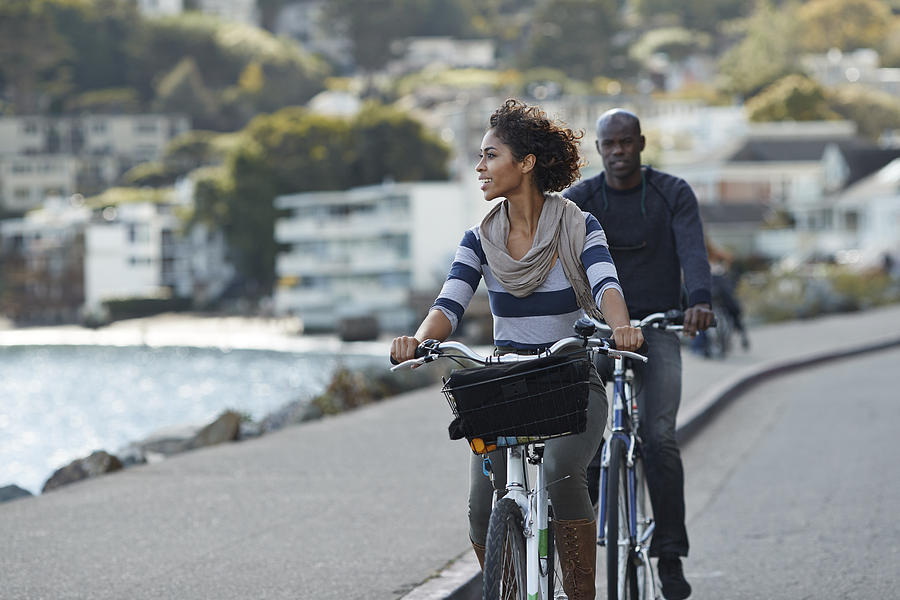 Couple using rental bikes in the small town Sausalito Photograph by Klaus Vedfelt