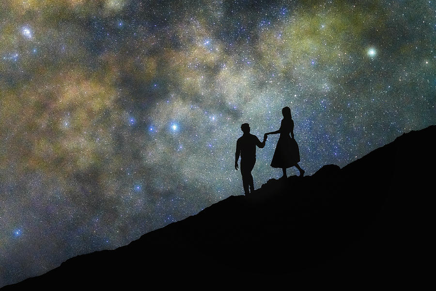 Couple walking in front of Milkyway in dark sky Photograph by Nutkamol Komolvanich