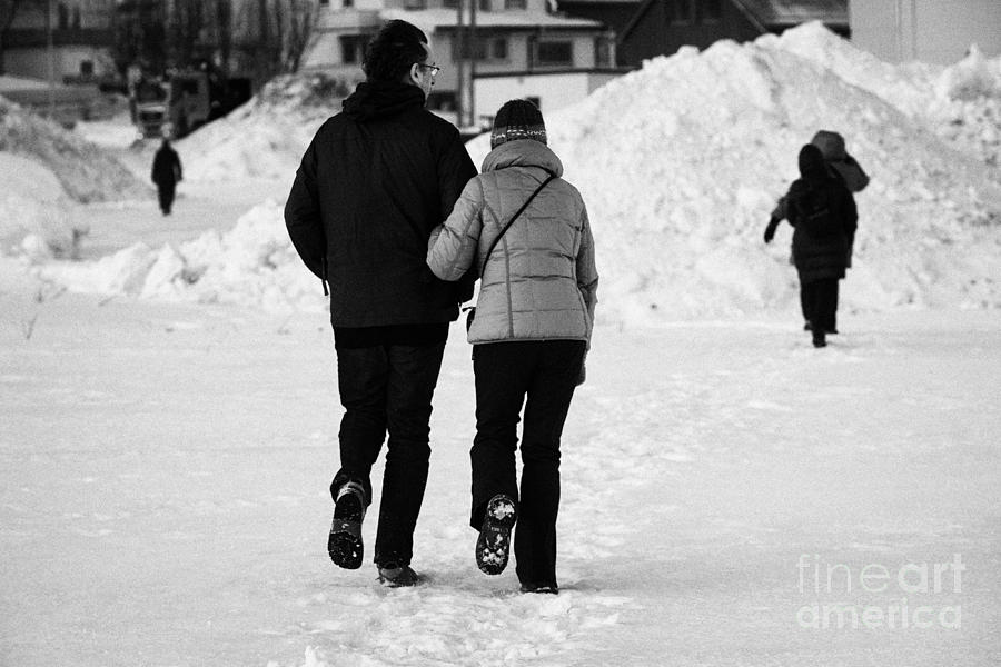 Couple Walking Through Ice And Snow Arm In Arm Kirkenes Finnmark Norway Europe Photograph By Joe Fox