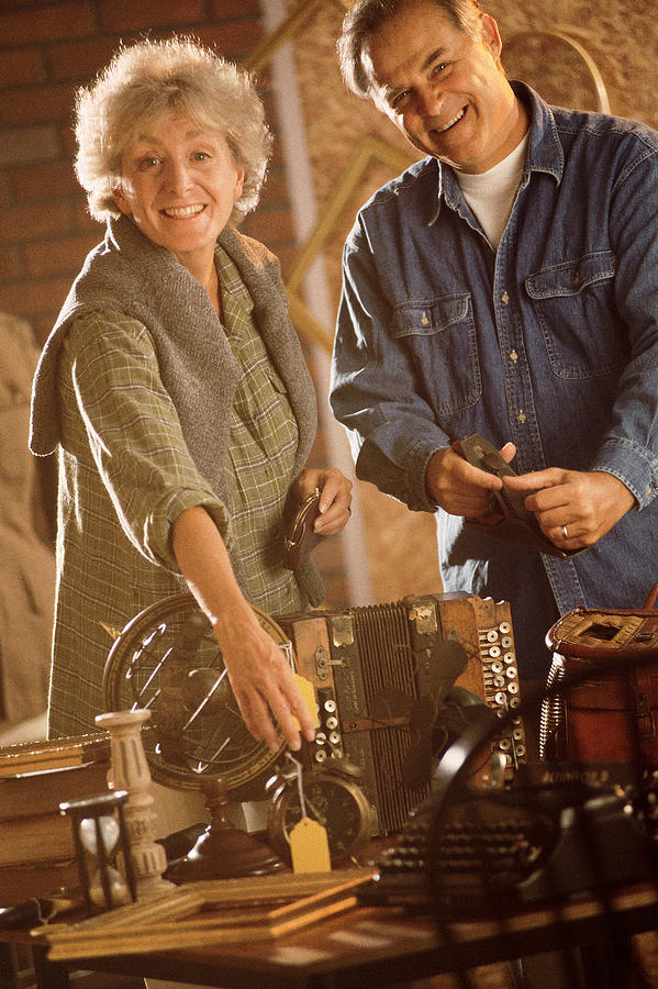 Couple with antiques Photograph by Comstock