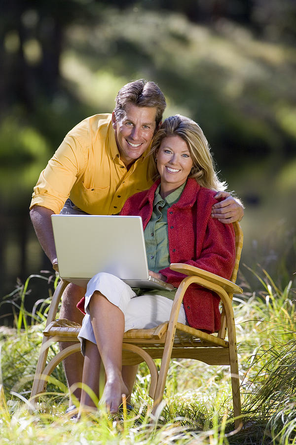Couple with laptop Photograph by Comstock Images