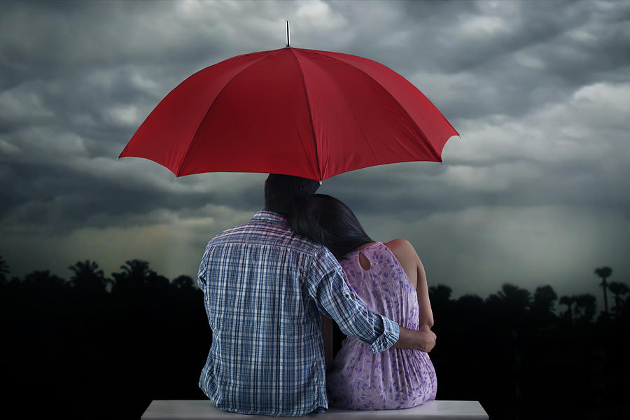 Couple with umbrella sitting Photograph by Abhinandita Mathur 