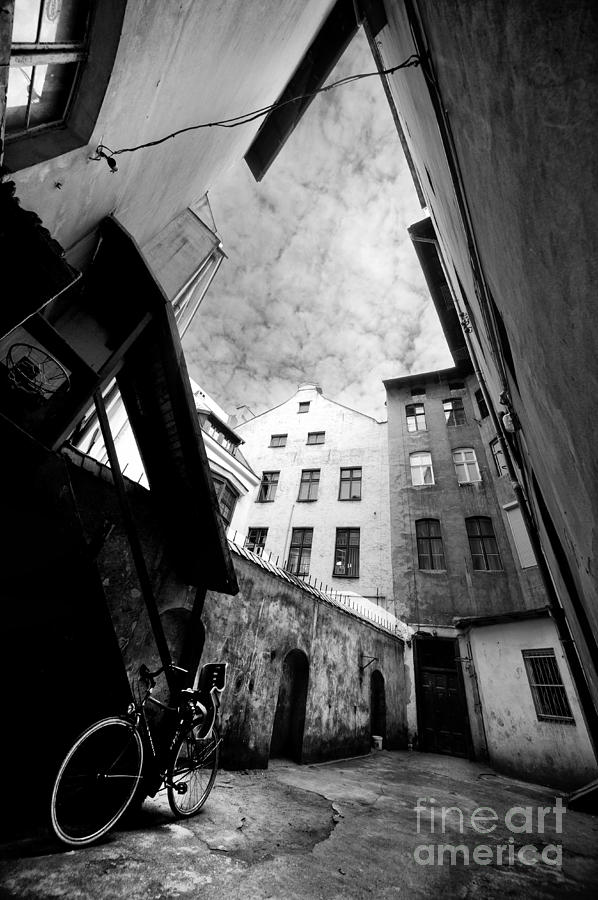 Courtyard with bike and buildings in black and white Photograph by Jaroslaw Blaminsky