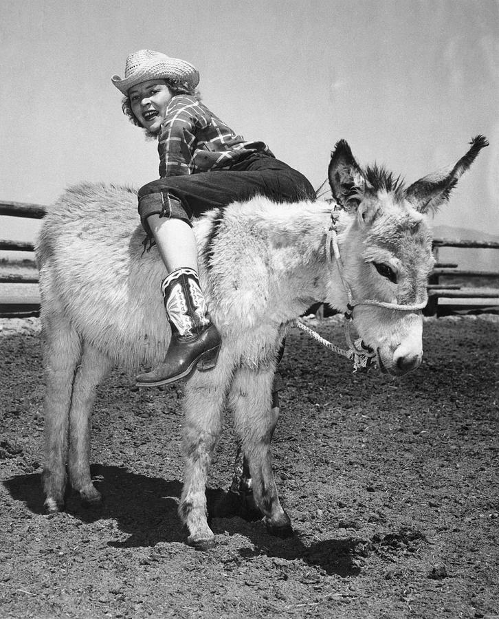 Cowgirl Backwards On A Donkey Photograph by Underwood Archives