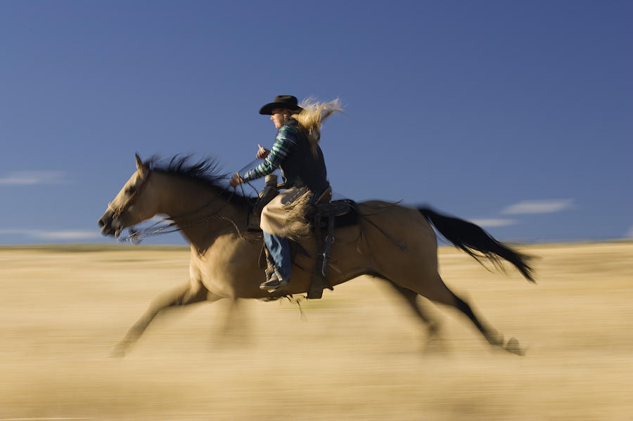Cowgirl Riding Through Field Oregon Photograph by Konrad Wothe