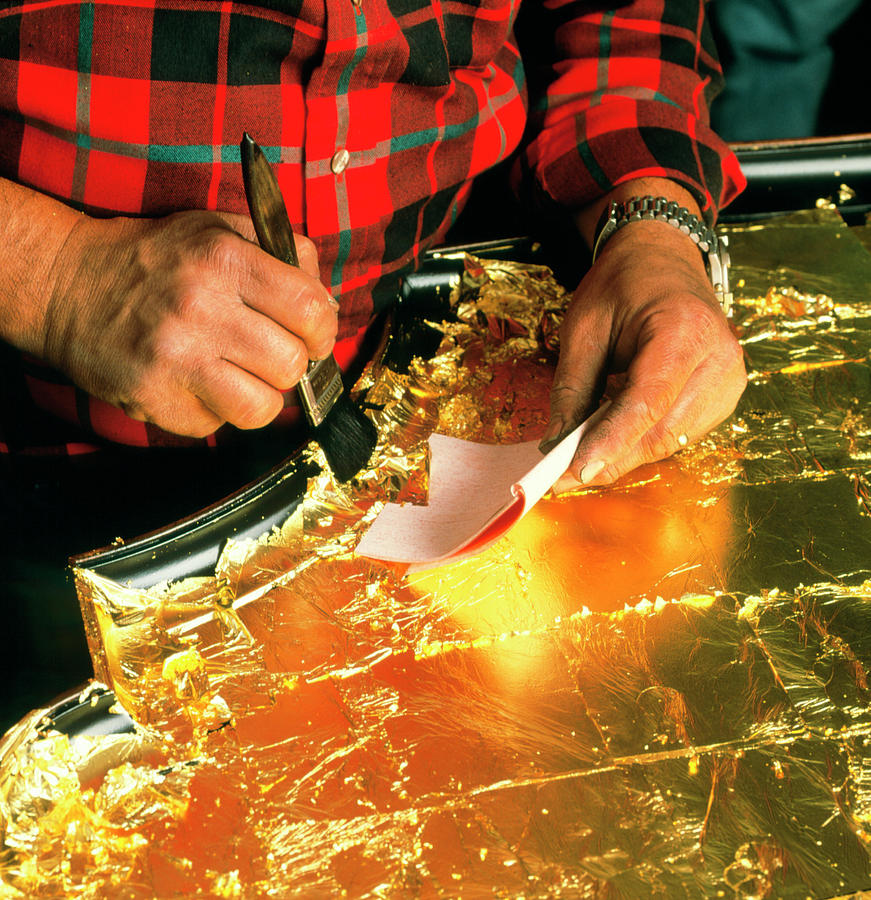 Craftsman Applies Gold Leaf To A Table Top Photograph by Sam Ogden/science Photo Library