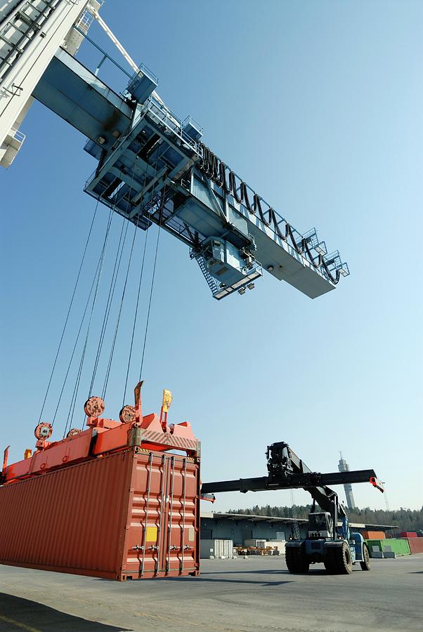 Crane Lowering Shipping Container Photograph by Christian Lagerek/science Photo Library