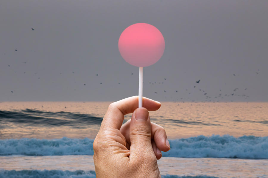Creative picture of sun like a lollipop in the beach. Photograph by Artur Debat