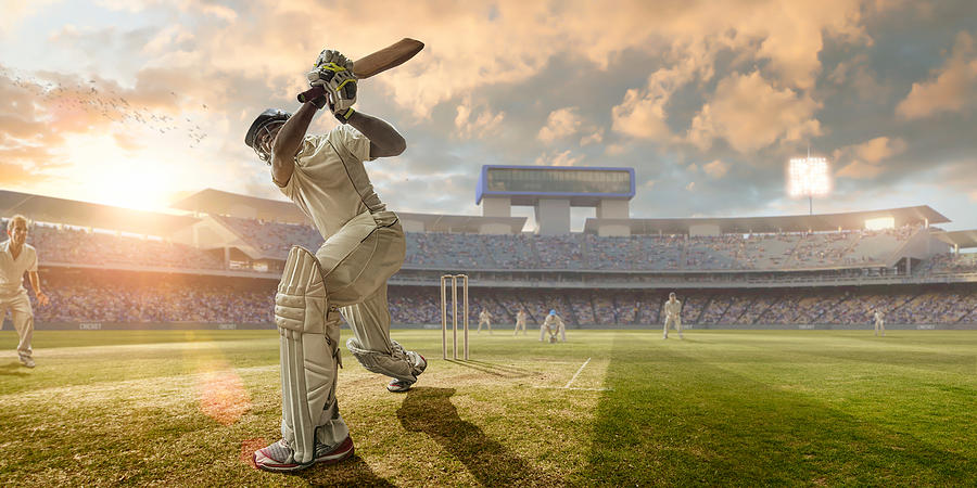 Cricket Batsman Hitting Ball During Cricket Match In Stadium Photograph by Peepo