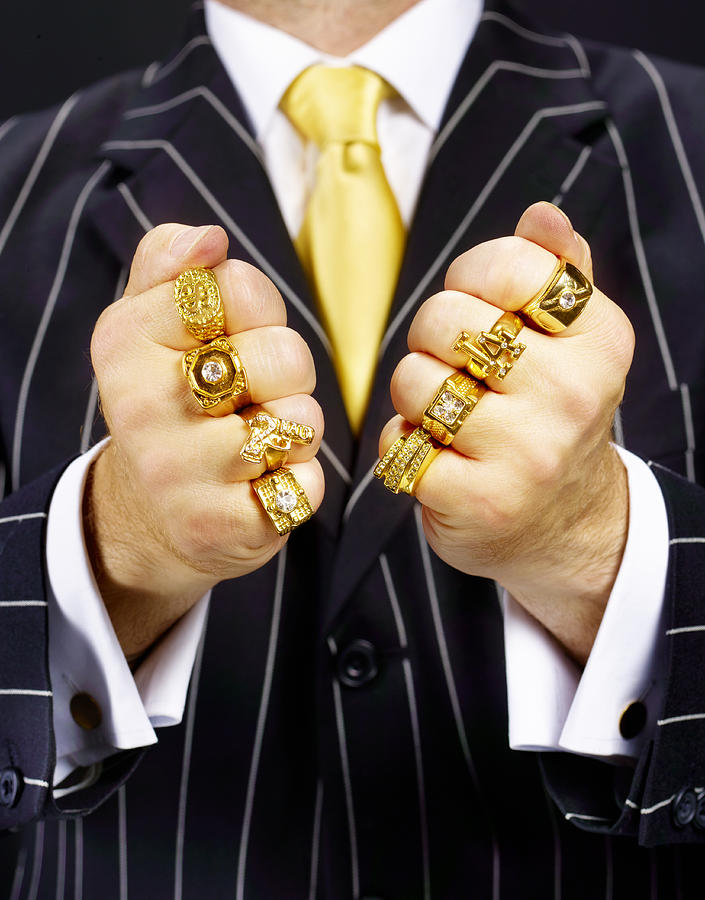 Criminal in suit wearing gold rings. Photograph by Peter Dazeley