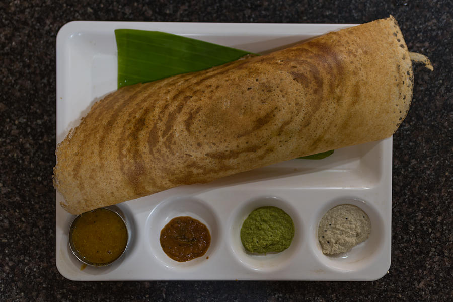 Crispy paper masala dosa (thosai) served on partitioned serving plate Photograph by Malcolm P Chapman