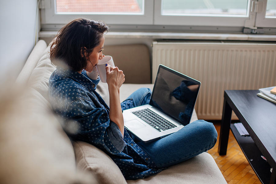 Cropped image of woman using laptop with blank screen Photograph by Agrobacter