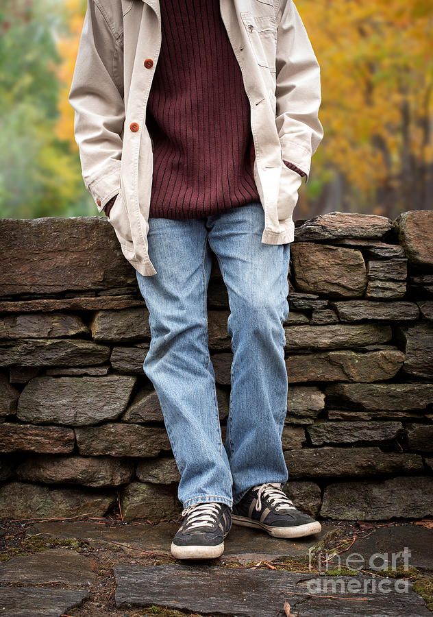 Fall Photograph - Cropped man standing against a stone wall by Edward Fielding